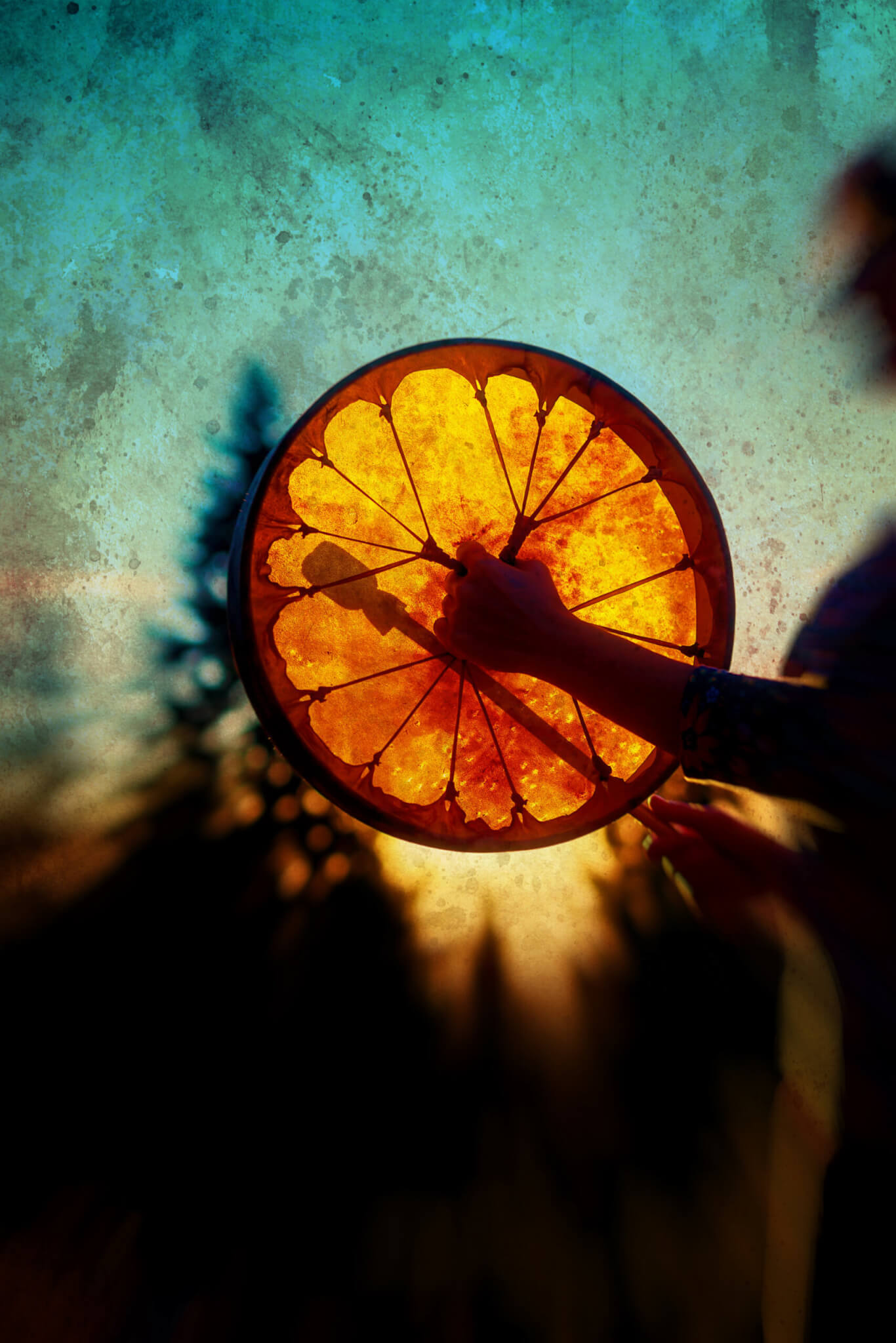 beautiful shamanic girl playing on shaman frame drum in the nature, old photo effect.